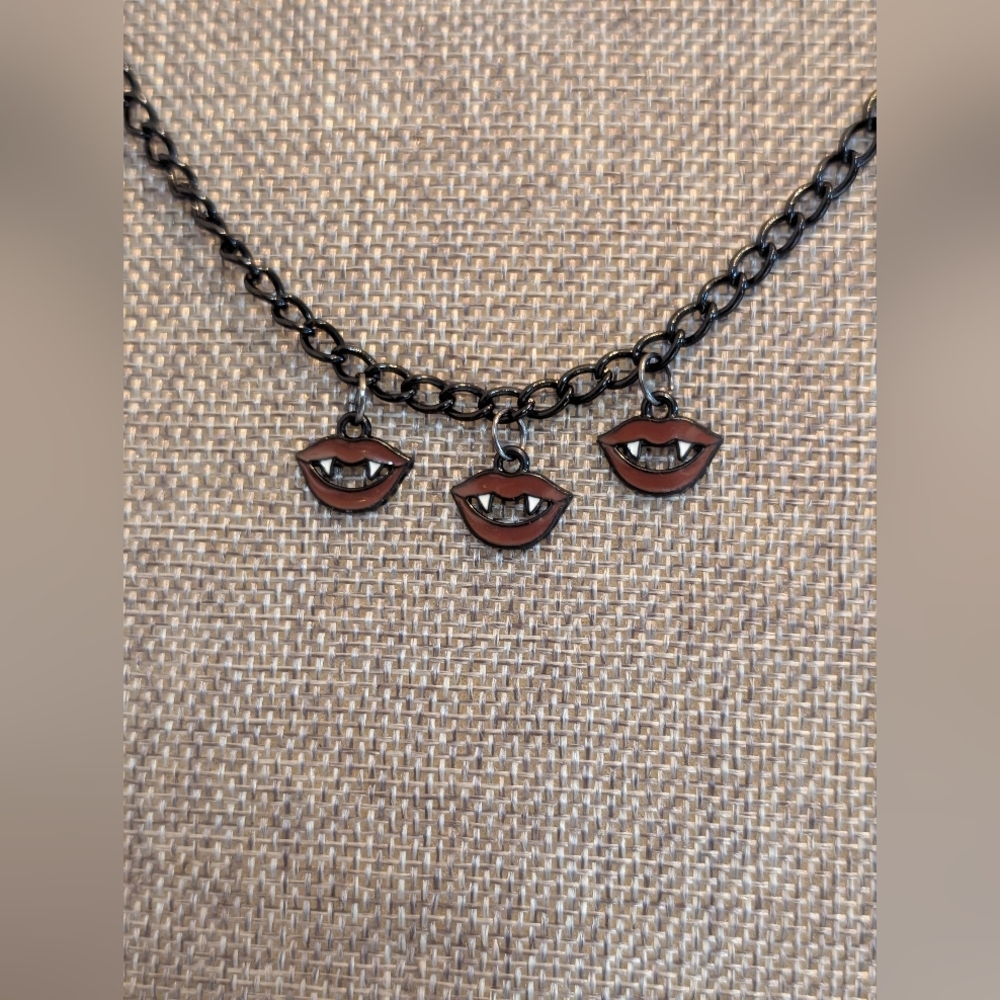 Black Chain Necklace with Vampire Teeth Charm.